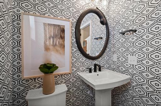 The main floor powder bath is in the ideal location and perfect for servicing the main level. (model photo)