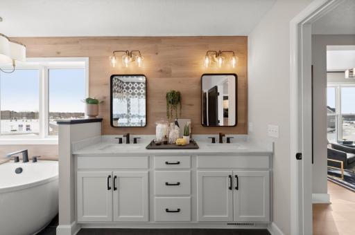 The owner's bath has everything you are looking for with a spacious closet, large two sink vanity, walk in shower, tub and ample storage space. (model photo)