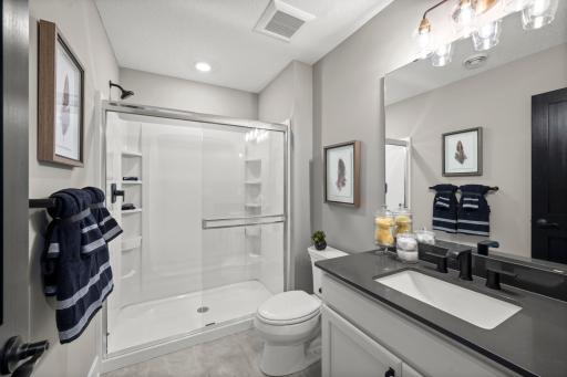 The lower level bath is stunning and spacious! It is ideal for servicing the lower level rec room, lower level bedroom, exercise room and athletic court. (model photo)