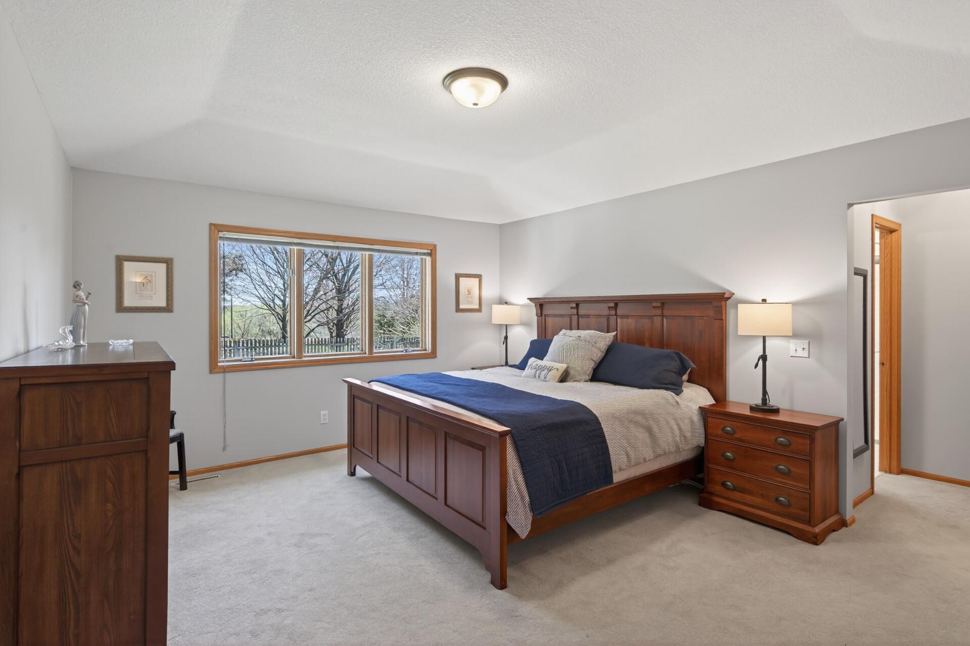 Main floor primary bedroom suite with tray vault ceiling