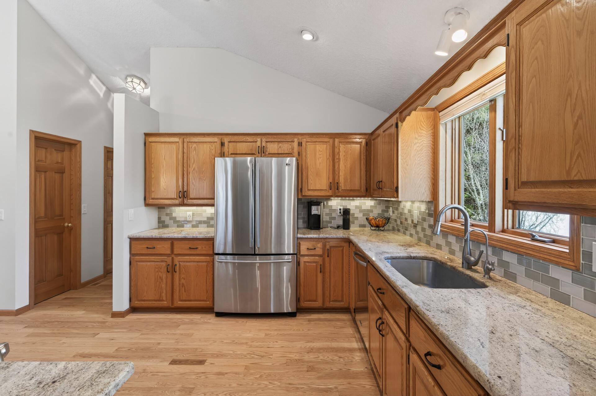 Another angle of the kitchen with the hallway leading to the laundry room & door to the garage