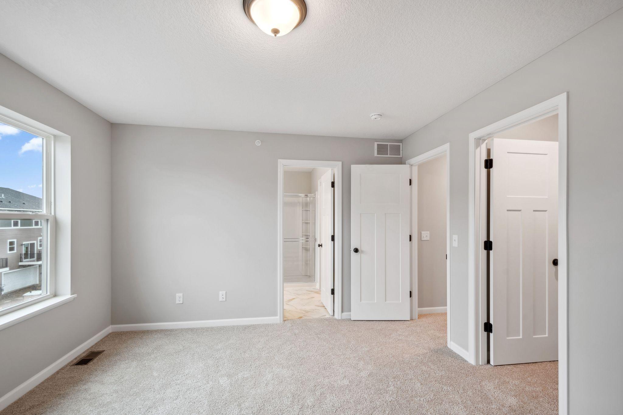 Primary en suite with two walk in closets