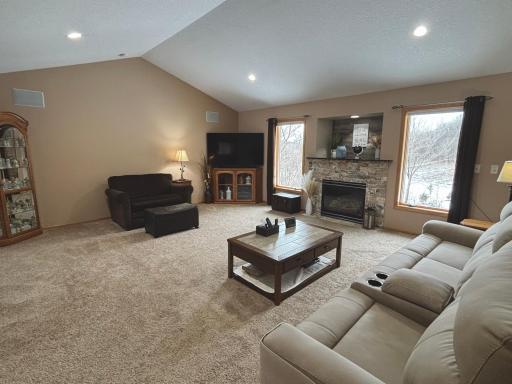 Warm and inviting living space with natural light and gas fireplace.