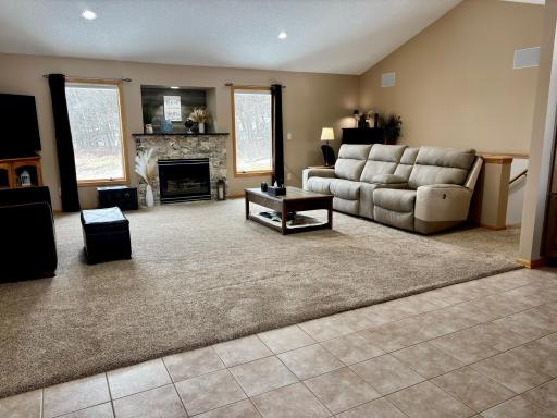 Warm and inviting living space with natural light and gas fireplace.
