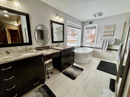 Luxurious primary en-suite with soaking tub and separate shower.