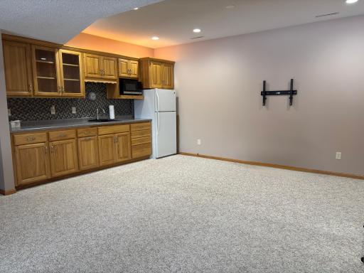 Finished walkout basement with wet bar and flexible living space.
