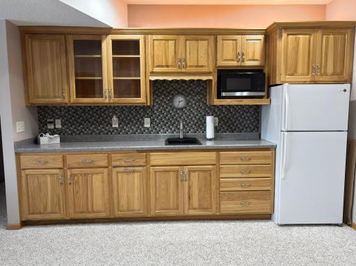 Wet bar with full size fridge and microwave.