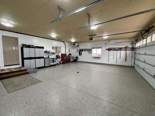 Heated attached garage with hot and cold water, floor drain, epoxied flooring and convenient basement access.