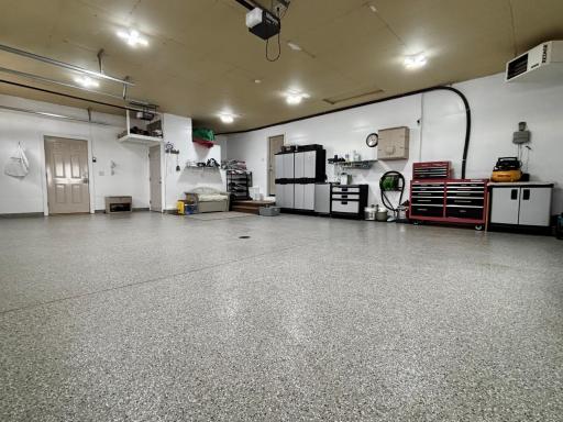Heated attached garage with hot and cold water, floor drain, epoxied flooring and convenient basement access.