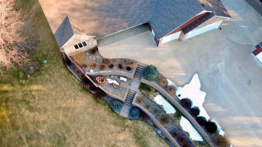 Beautifully landscaped yard with thoughtfully designed retaining walls creating visual interest and functional outdoor spaces.