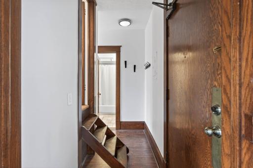 Front foyer of unit with stairs that lead up to a spacious walk-in closet and built-ins!