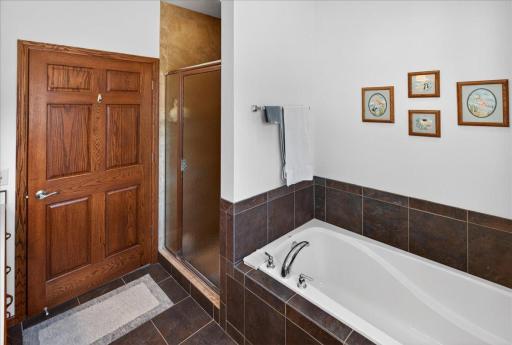 Primary bath includes a separate shower and soaking tub for comfort and convenience.