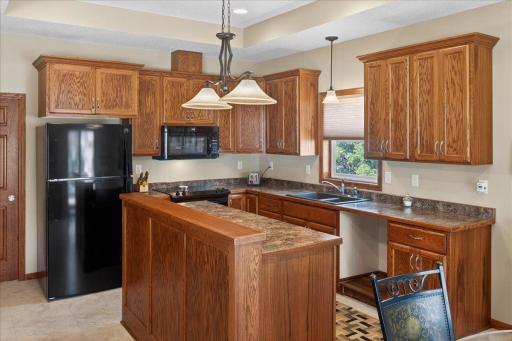 Well-designed kitchen with ample counter space, double sink with window views, and convenient center island for additional prep and seating.