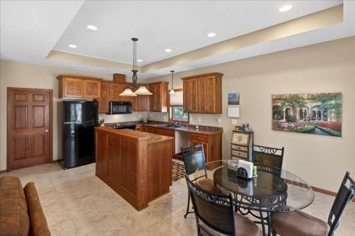 Open and functional kitchen featuring abundant cabinet space, center island, recessed lighting, and seamless flow into the dining area.