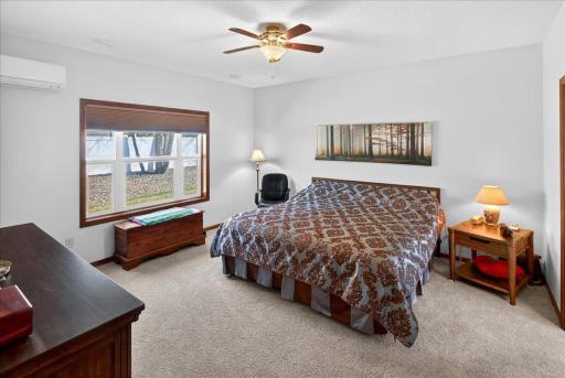 Spacious primary bedroom featuring a large window for natural light, two walk-in closets, and a private en-suite primary bathroom.