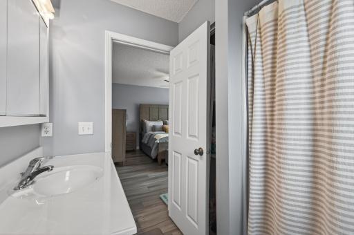 Additional bathroom angle showcasing clean finishes, brand new luxury vinyl plank (LVP) flooring, and bright natural lighting.