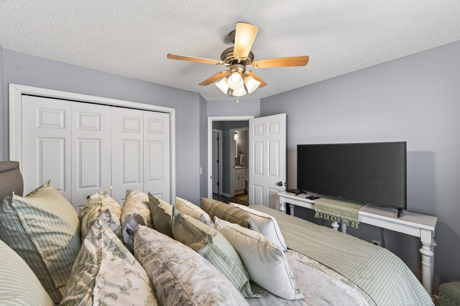 Alternate view of second bedroom showcasing fresh paint, a spacious layout, ample closet space, and convenient access to the adjacent bathroom.