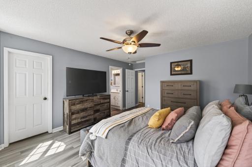 Primary bedroom angle highlighting a walk-in closet and private 3/4 bathroom.