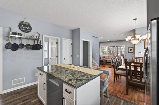 Updated kitchen featuring a large center island, stainless steel appliances, and an open flow into the dining and living areas; perfect for everyday living and entertaining.