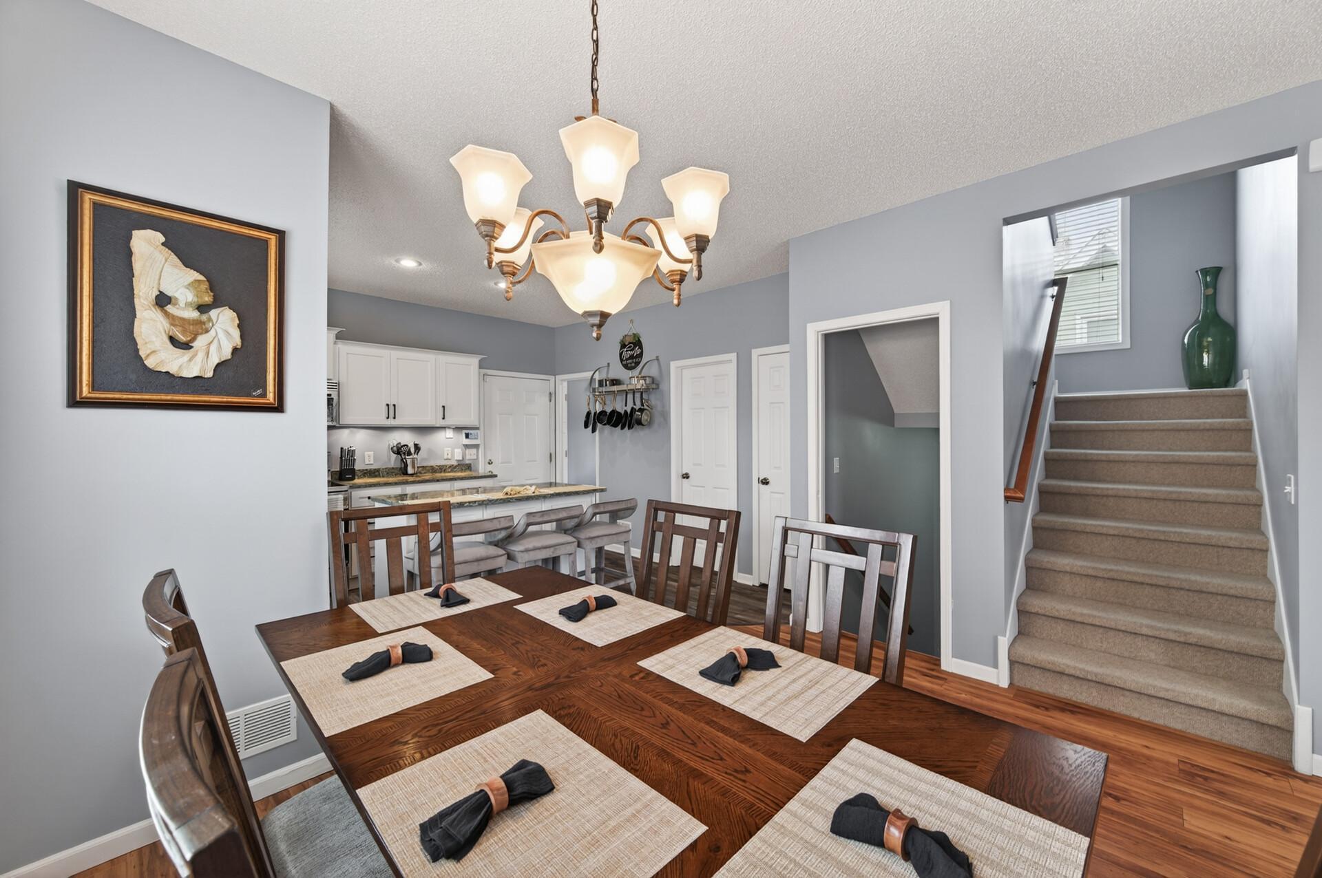 Open dining space with direct access to the kitchen and nearby staircase, providing a practical and connected layout.