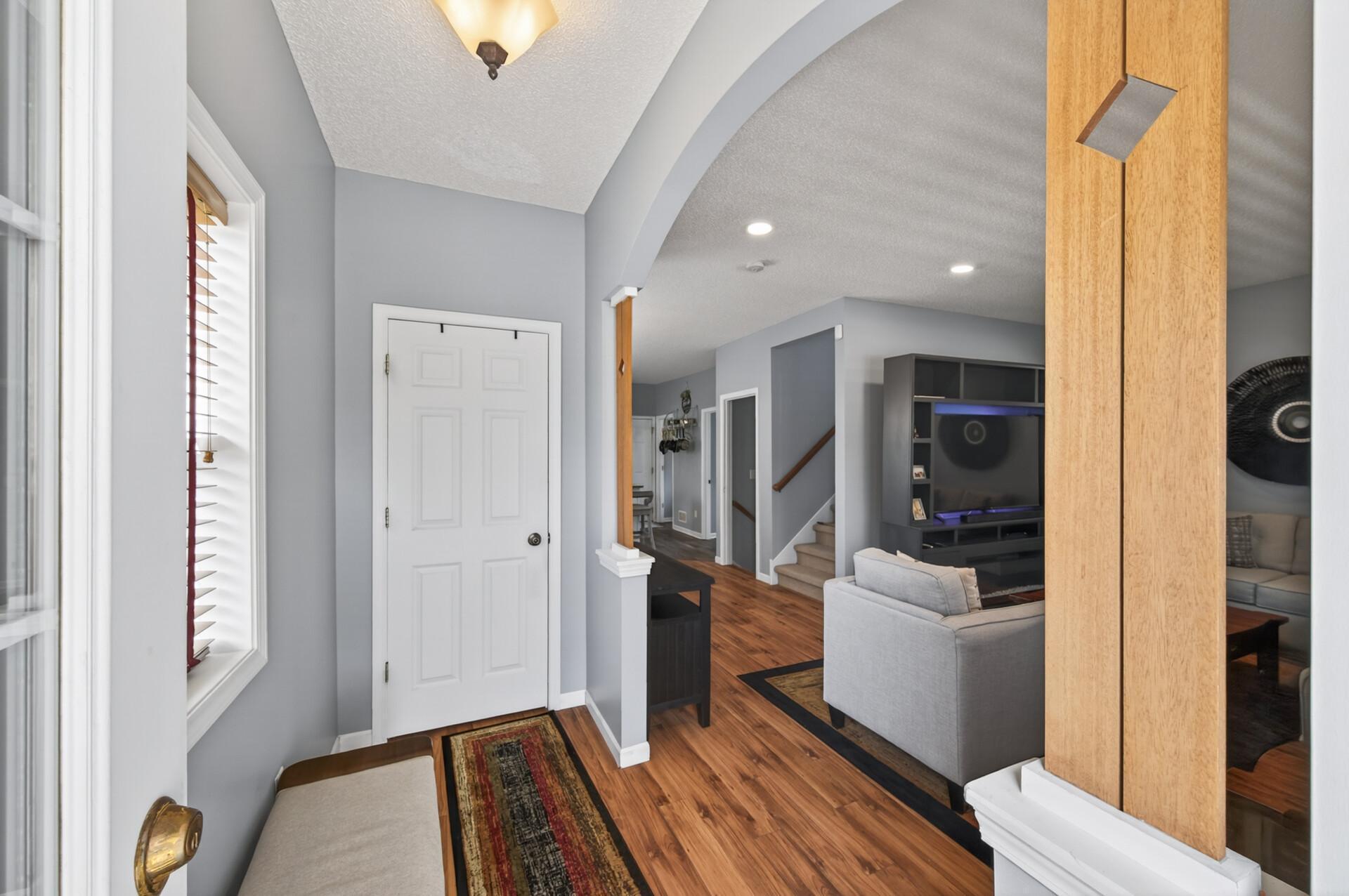 Bright and welcoming entryway with neutral tones and durable flooring that flows seamlessly into the main living areas. Open sightlines create an immediate sense of space upon entering.