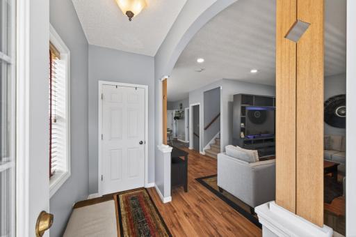 Bright and welcoming entryway with neutral tones and durable flooring that flows seamlessly into the main living areas. Open sightlines create an immediate sense of space upon entering.