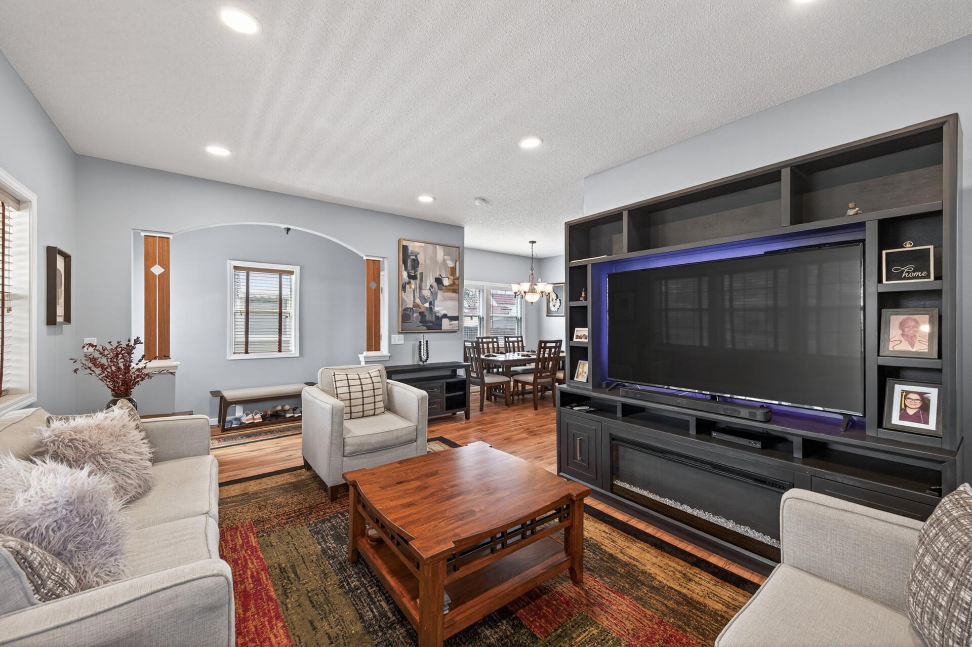 Comfortable and stylish living room with ample seating space. The open flow connects seamlessly to the dining and kitchen areas, ideal for everyday living and entertaining.