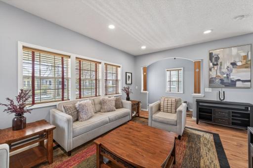 Light-filled living room featuring brand new LED lighting and large windows that invite abundant natural light, offering a comfortable balance of openness and warmth.