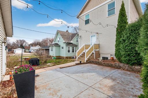 Enjoyable backyard featuring a blend of open green space and hardscaping, offering plenty of room for gardening, play, or relaxing outdoors.
