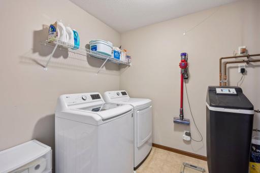 Upper level laundry room with space for storage and shares space with the mechanicals. You'll appreciate the owned water softener.