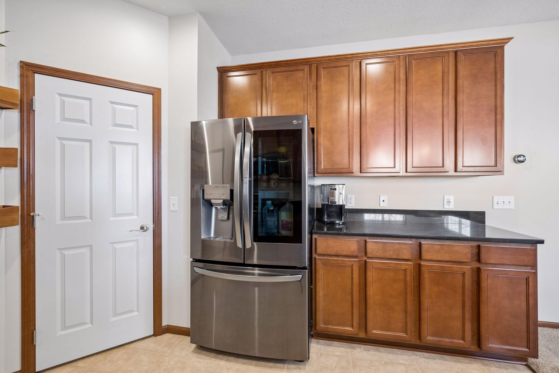 Amazing fridge and more counter space! The door opens to the walk-in pantry.