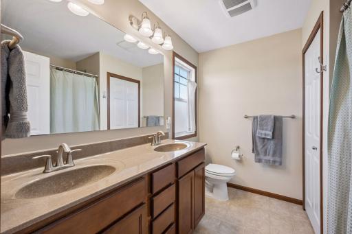 Primary full bath with dual sinks, linen closet and a window that opens!