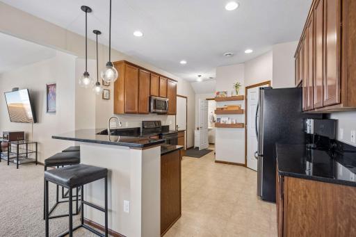 This extra large kitchen is updated with granite counters and black stainless appliances. Nice walk-in pantry with lots of space. Please exclude wall shelves. Garage entry and 1/2 bath complete this level.