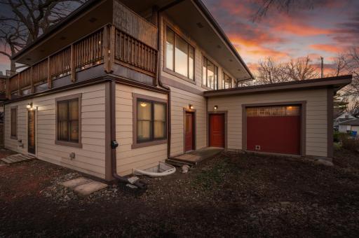 Garage has a service door and second garage door facing into the backyard