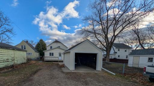 Alley level view of open garage and extra parking