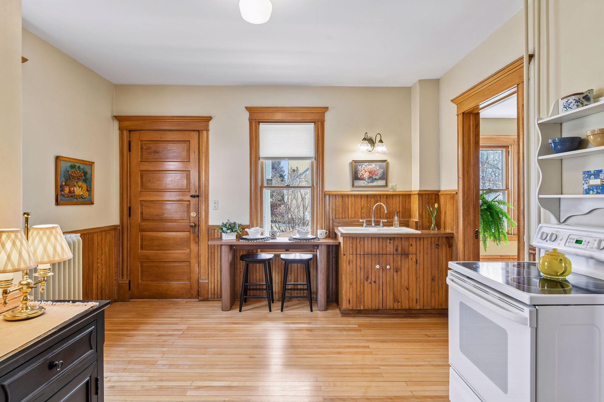 The rich maple floors carry through into the kitchen, adding warmth and continuity.