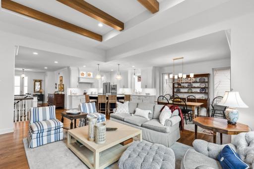 Open-concept layout with soaring ceilings and exposed beams