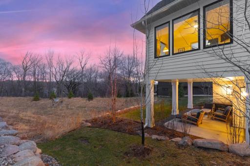 Hilltop setting surrounded by mature trees and lush landscaping