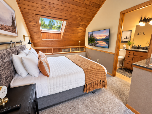 Master lofted bedroom with TV and ensuite bathroom.png