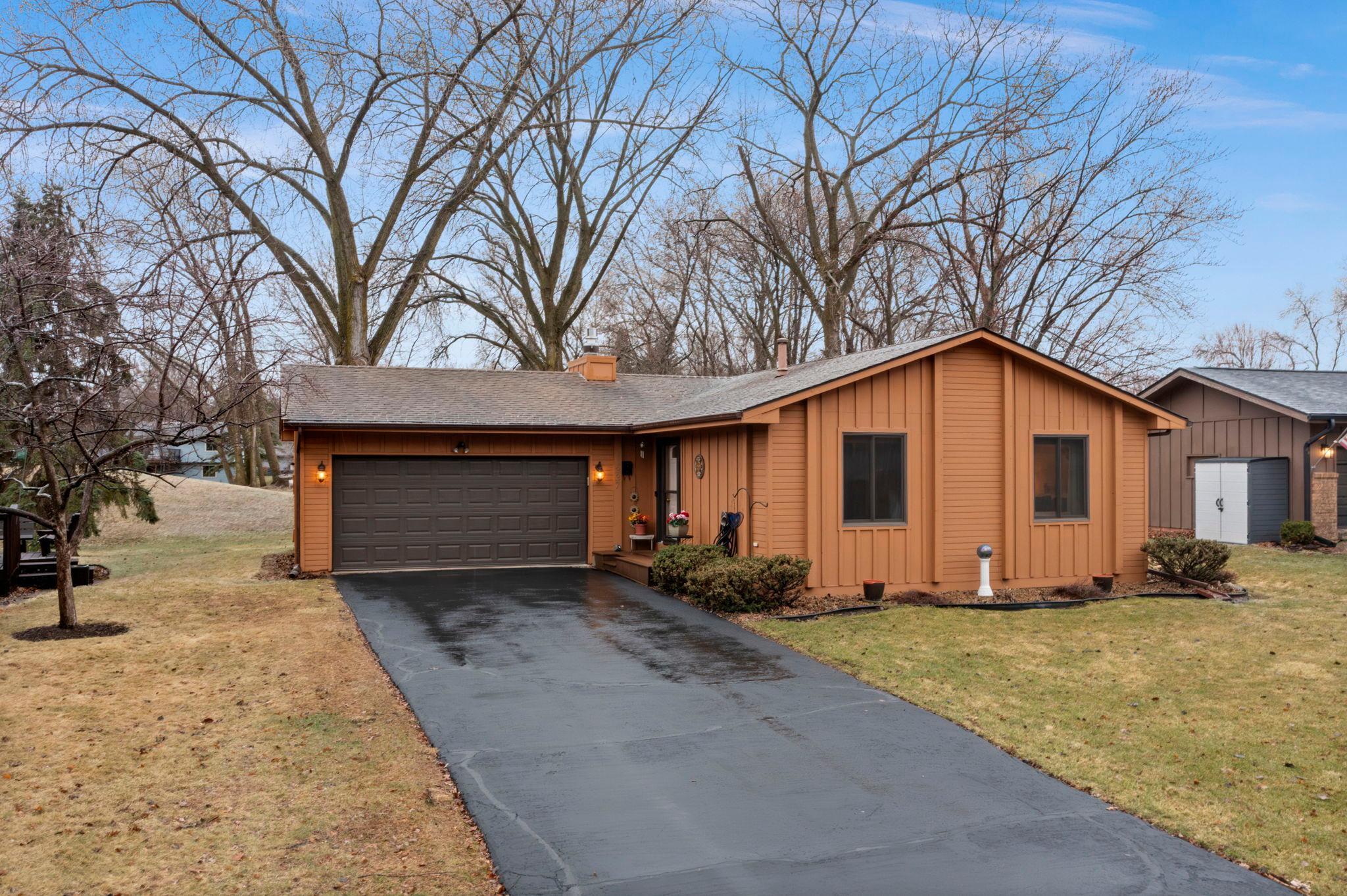 New asphalt driveway seal coated in 2025.