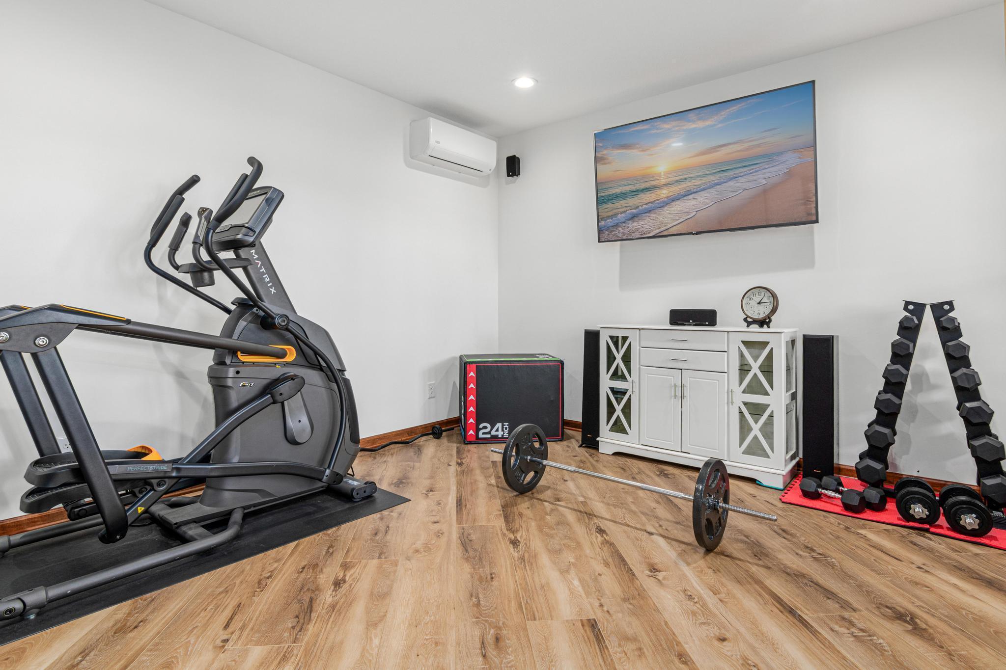 Versatile exercise room easily functions as an additional bedroom or wellness retreat.
