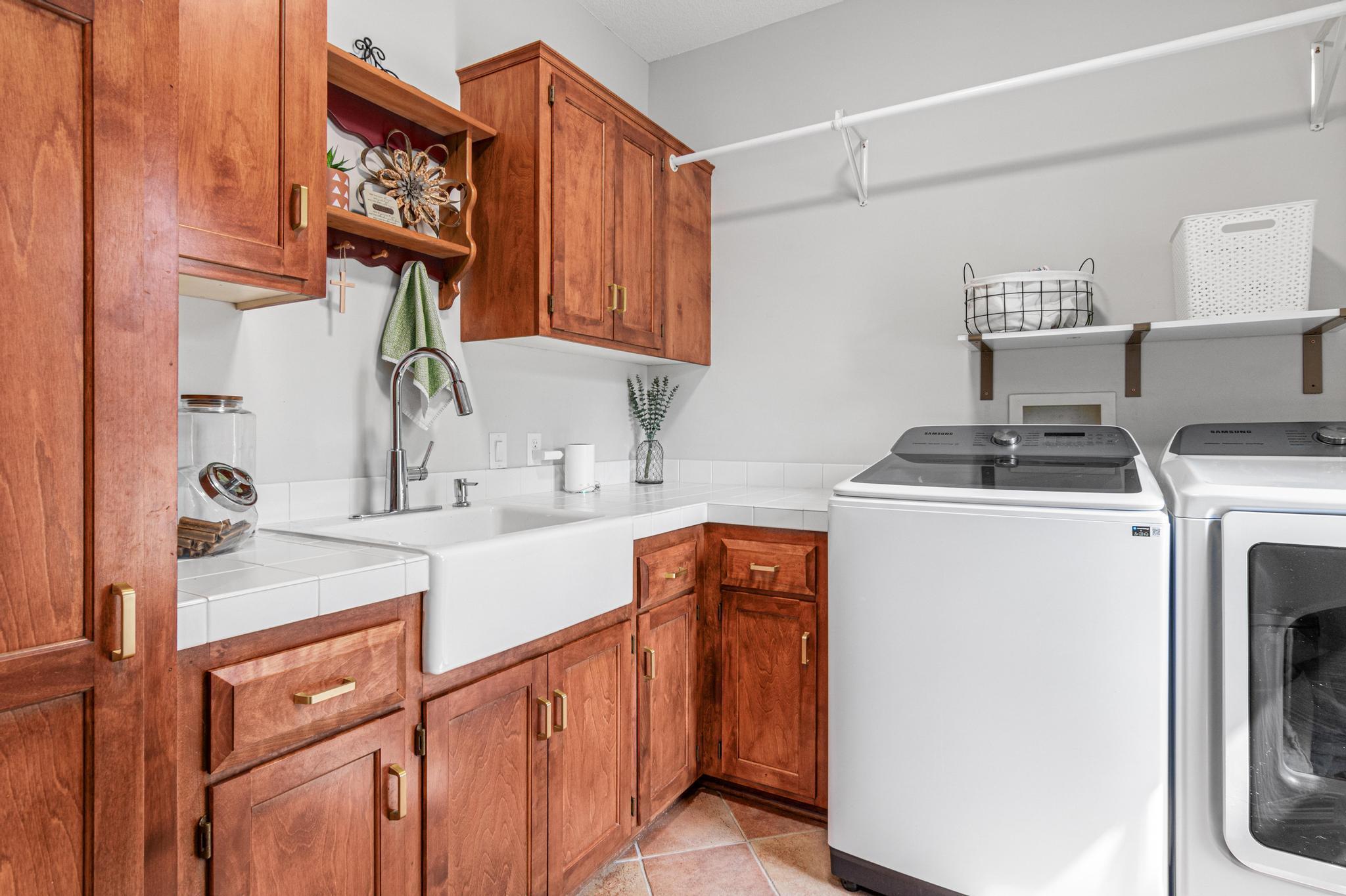 Beautifully appointed laundry room is located off the 3-car garage and provides great storage and counter space for chores. New washer/dryer in 2026.