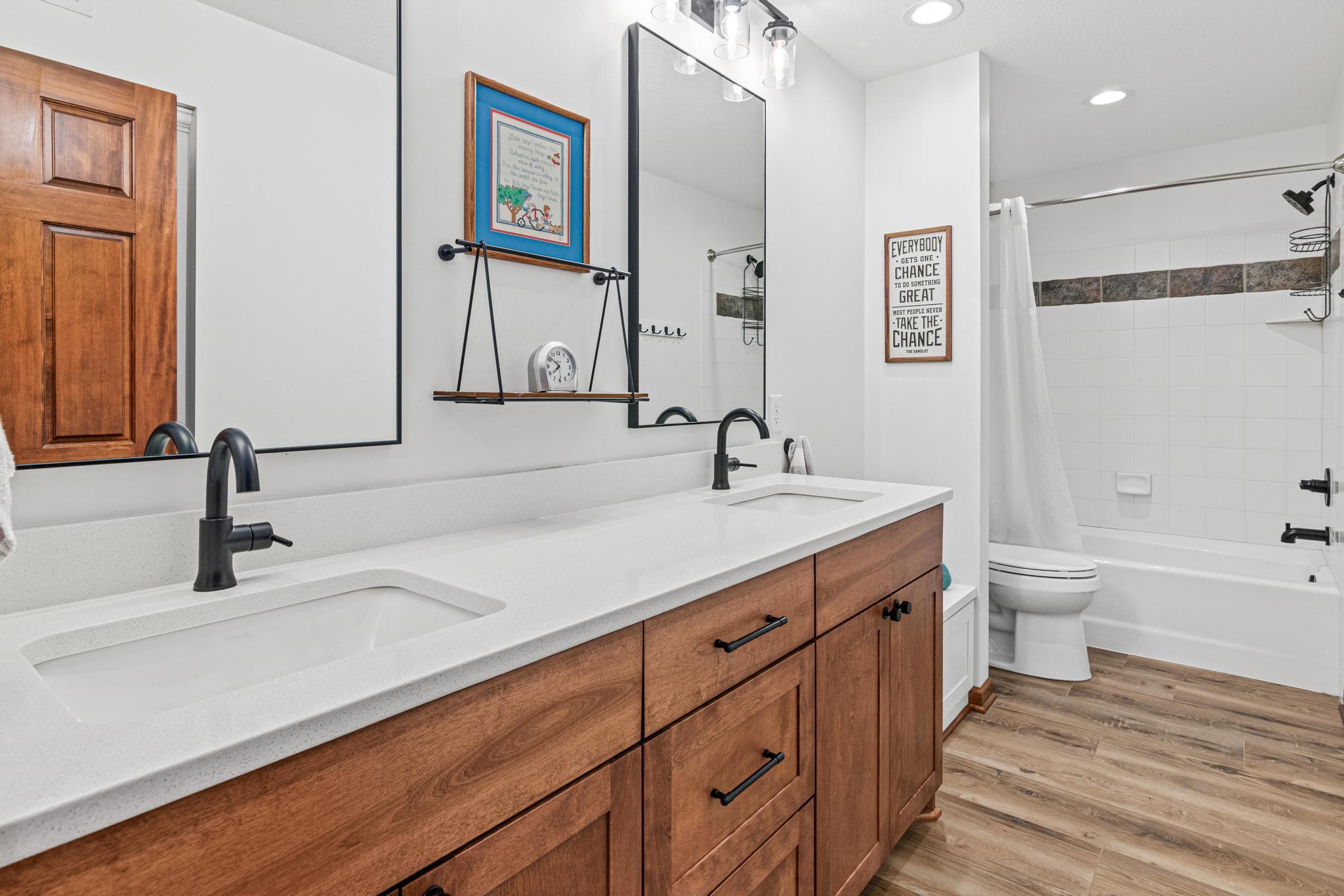 Updated lower-level bathroom with double sinks, great storage and more!