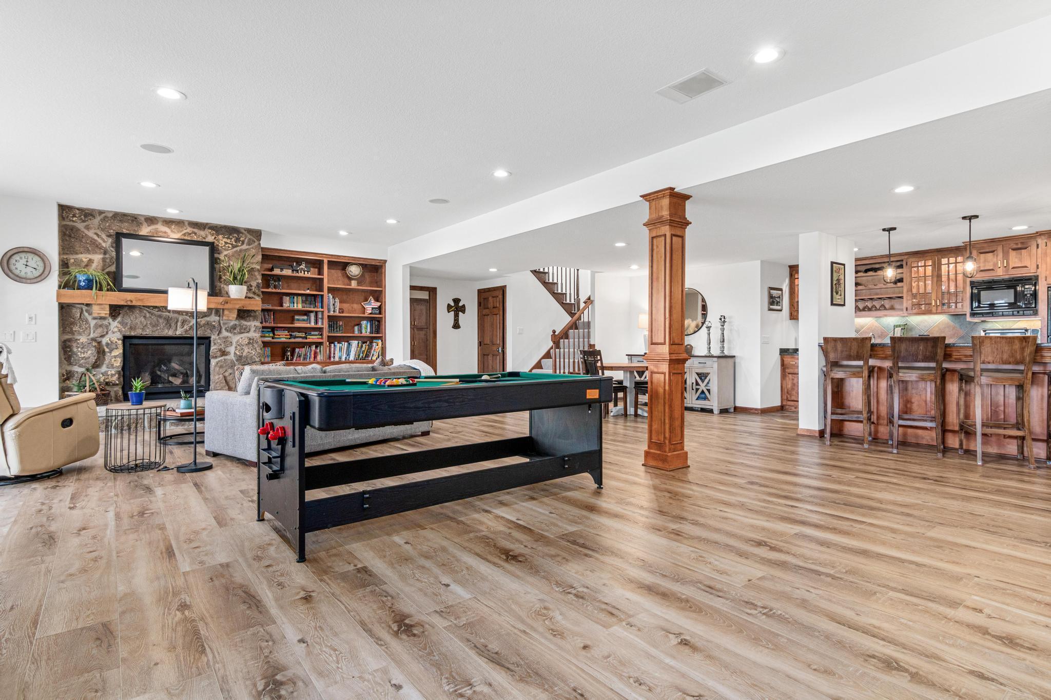 Expansive walkout lower level with new LVP flooring and lighting, designed for comfortable living and elevated entertaining.