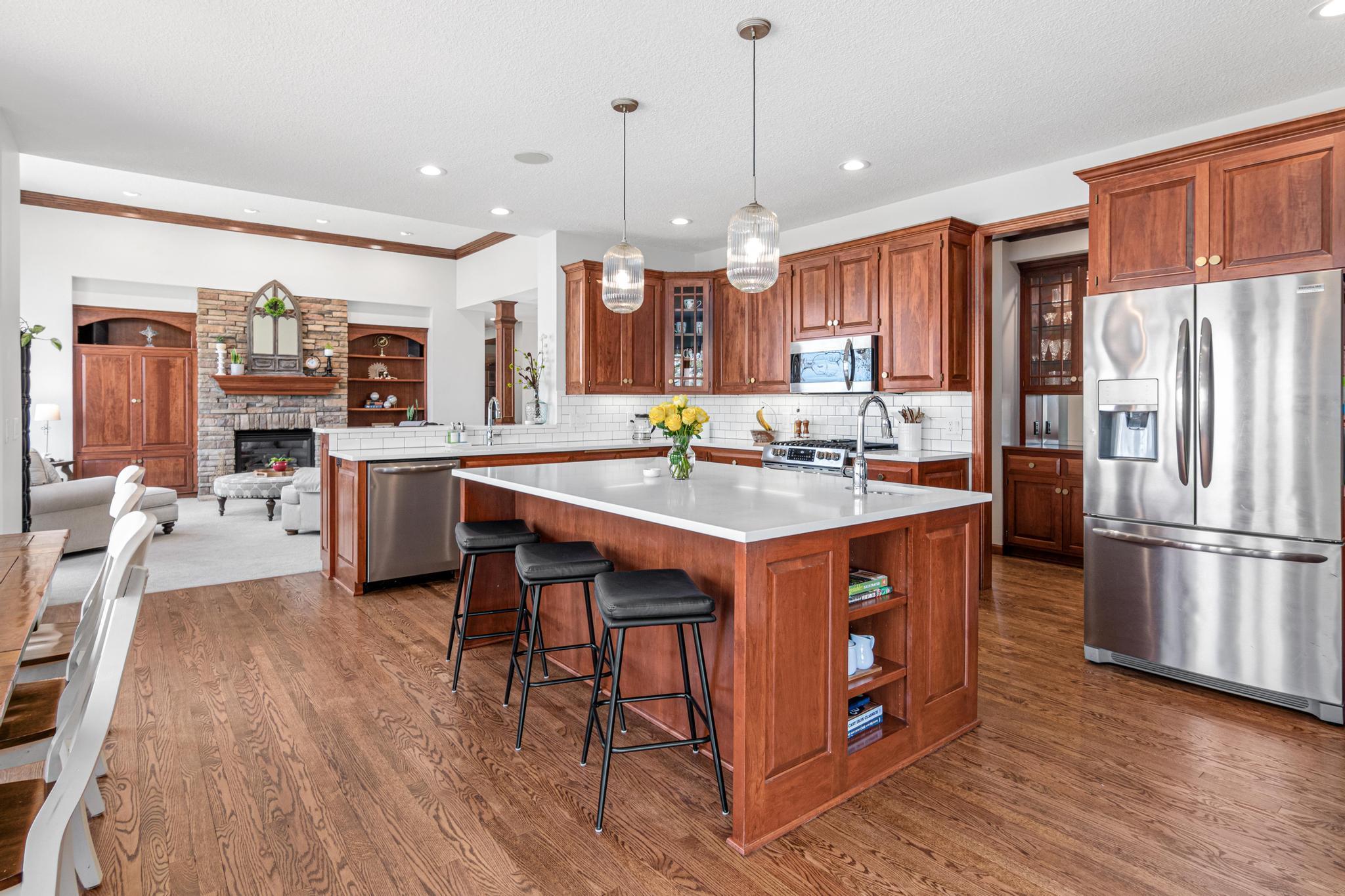 Gourmet kitchen with rich cherry cabinetry, high-end finishes, and ample space for cooking and gathering.