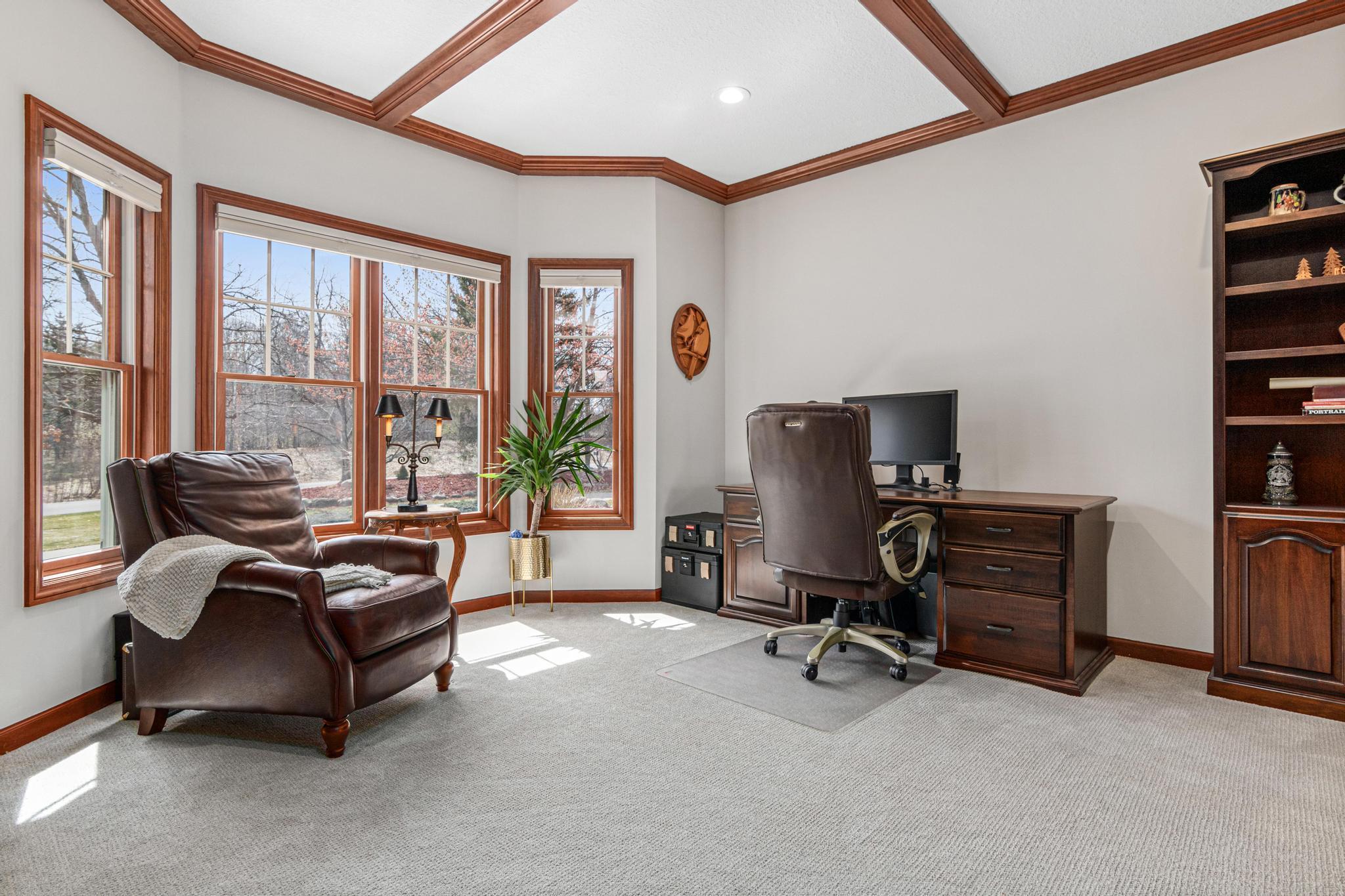 Executive office is perfect for working from home and provides beautiful views to the front yard.