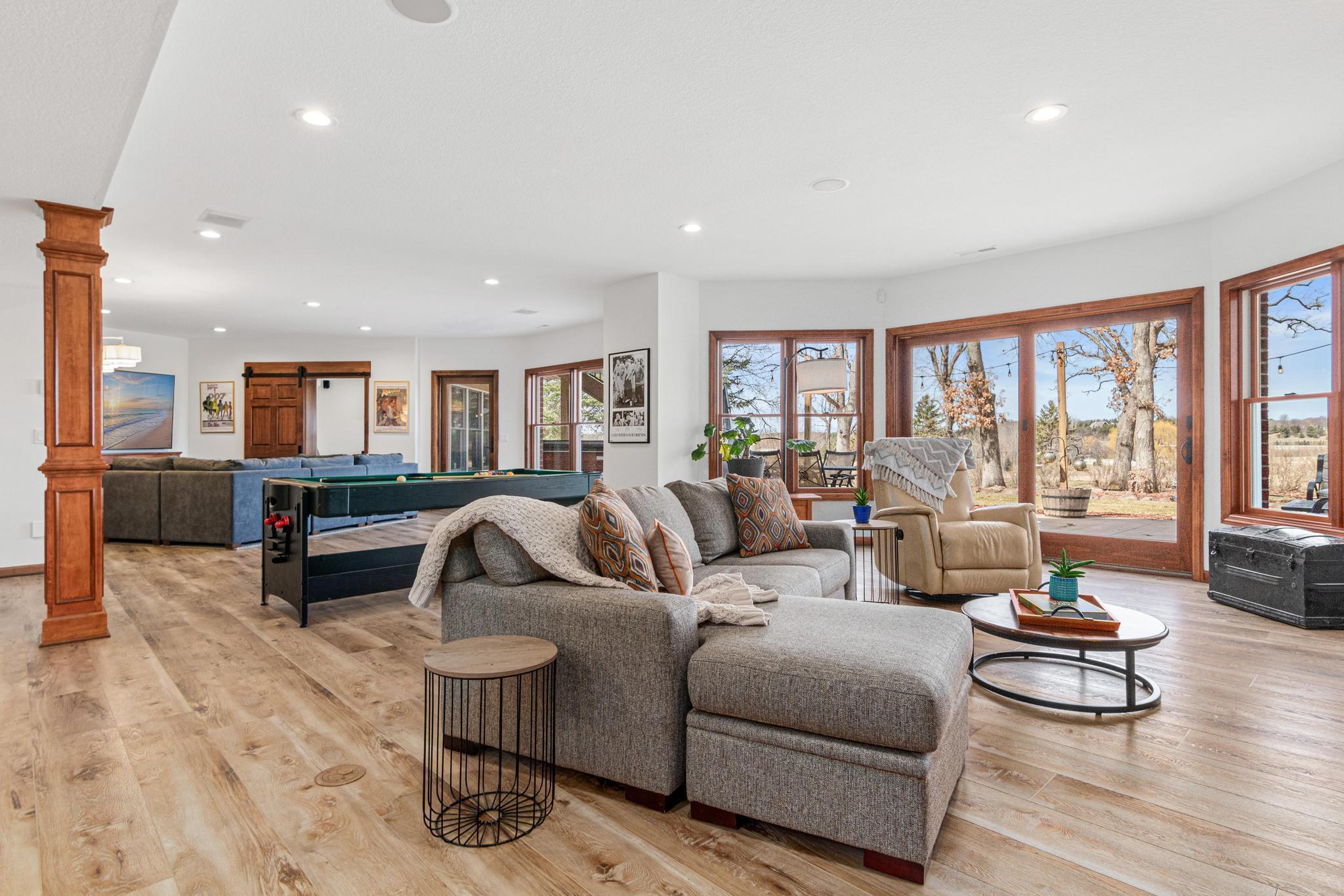 Expansive walkout lower level with new LVP flooring and lighting creates the perfect space for entertaining.
