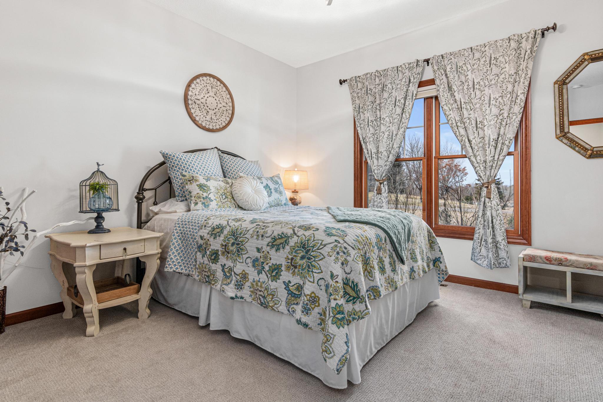 Main-level guest bedroom offers comfort and convenience for visitors. Beautiful views of the property and great natural light.