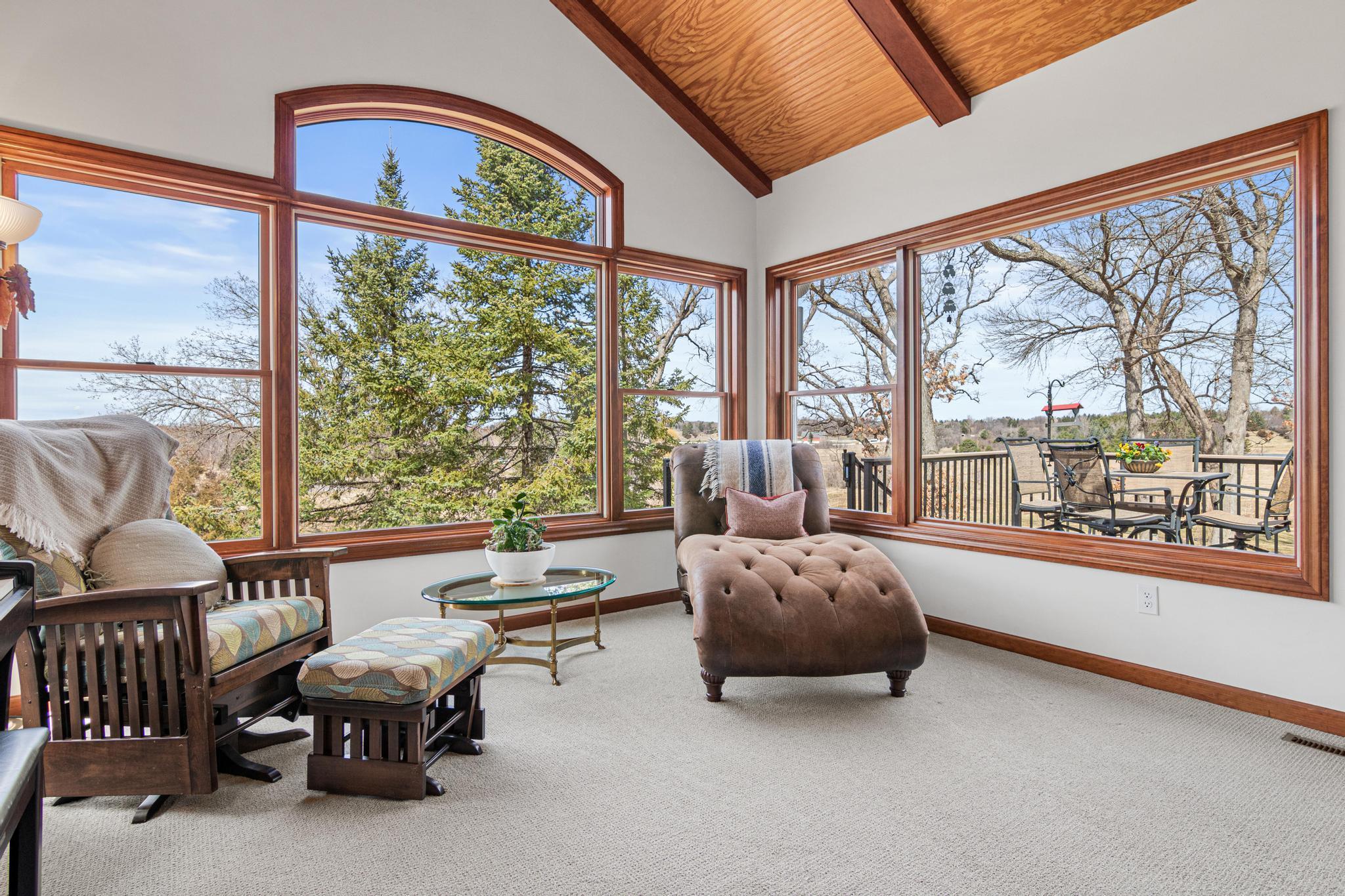 Inviting sunroom offers a peaceful space to enjoy panoramic views year-round.