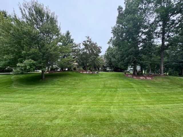 Check out the green grass, beautiful perennial gardens, tree filled yard and more!